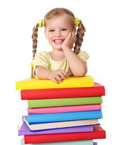 Little-girl-holding-pile-of-books